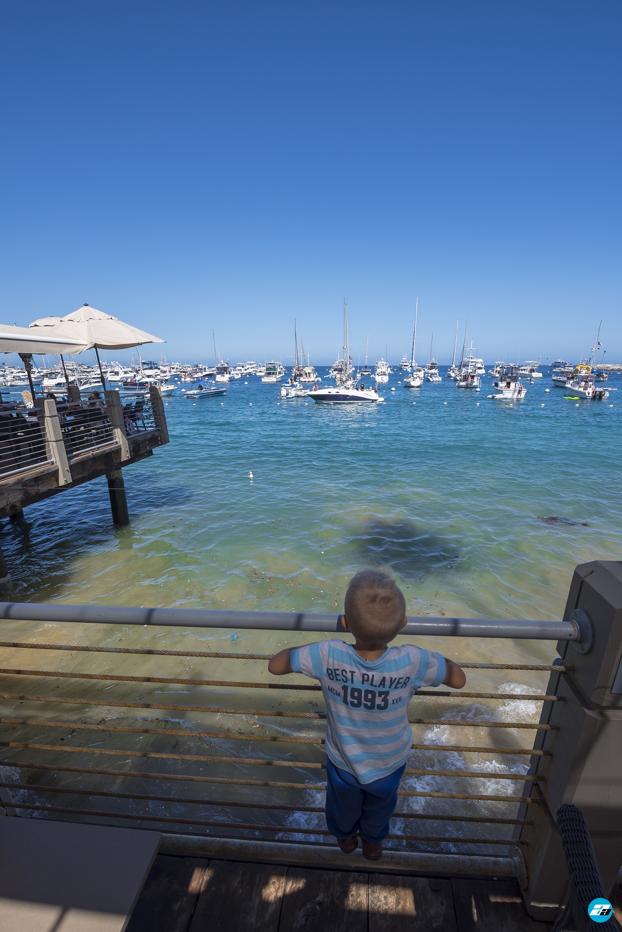 Catalina Island, Chanel Islands National Park, California, Pier. Boats in Water. Child looking.