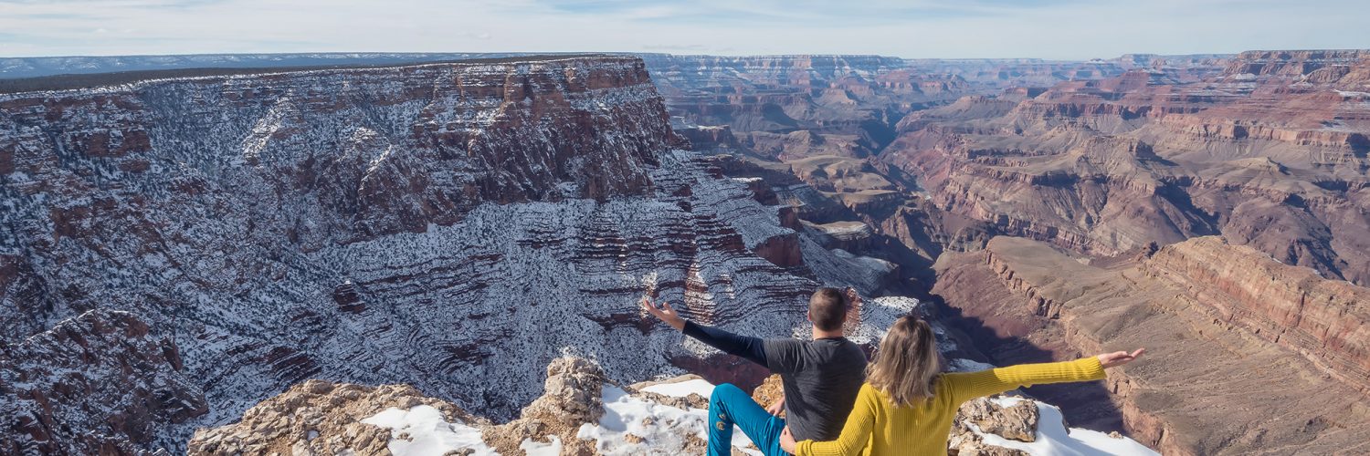 Grand Canyon National Park, Arizona, USA. Canyon View. Explorers. Winter Season. Arizona Attraction & Travel. Canyon Snow. Couple. Back View.