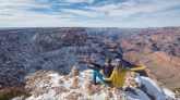 Grand Canyon National Park, Arizona, USA. Canyon View. Explorers. Winter Season. Arizona Attraction & Travel. Canyon Snow. Couple. Back View.