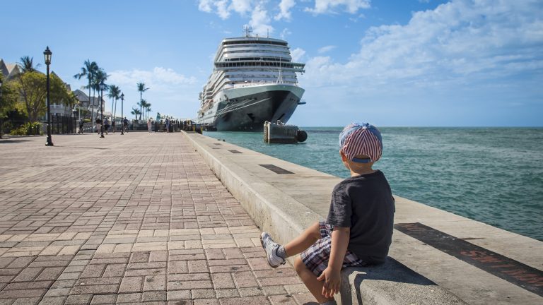 Key West, FL. Cruise Ship, Port. Sunset Pier. Boy Sitting and watching.